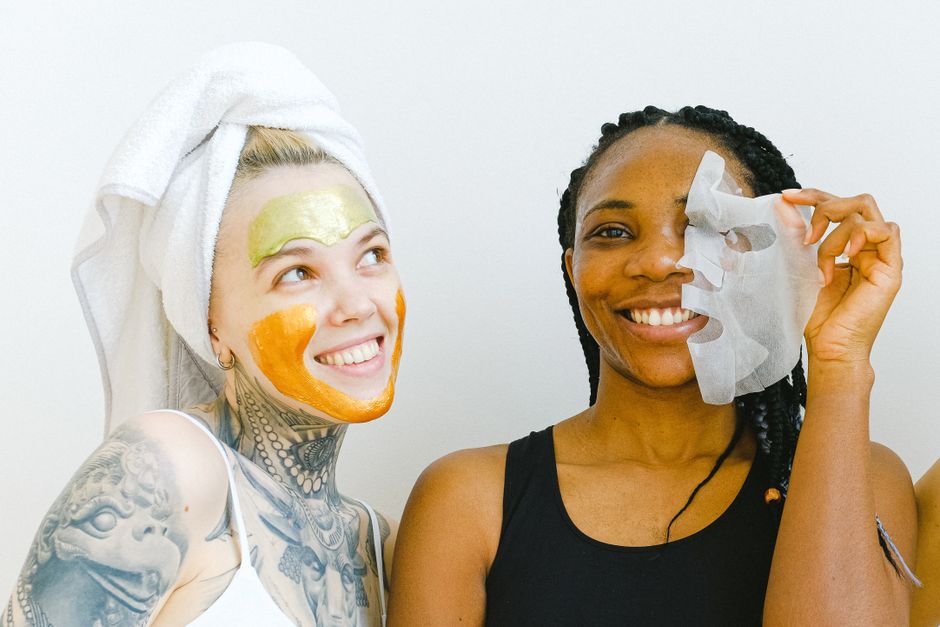 A person wearing a lit LED skincare face mask