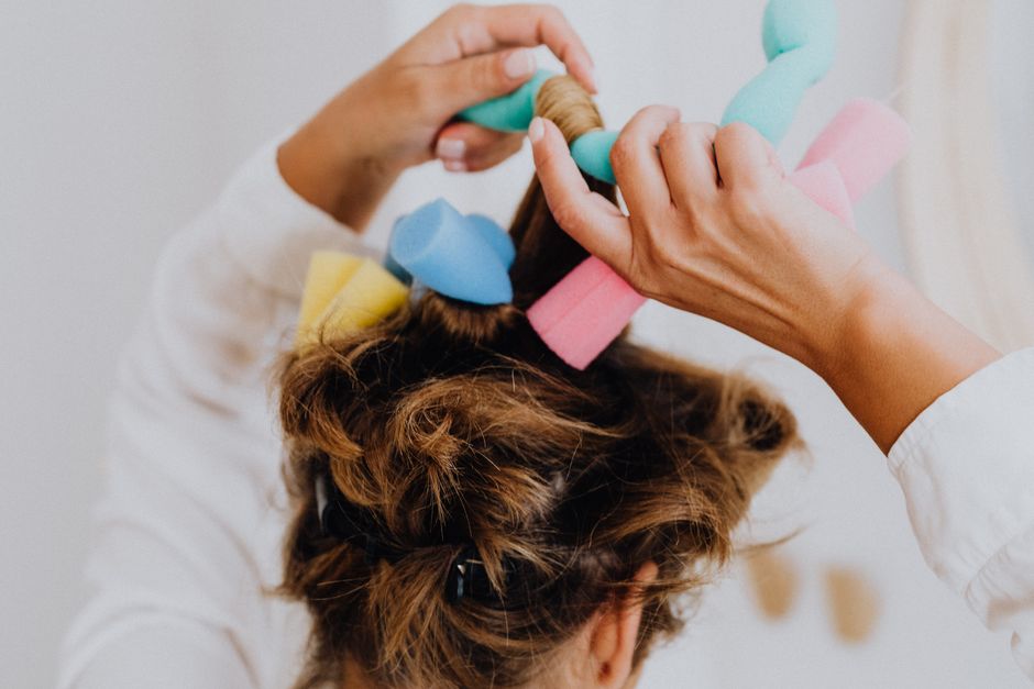 Air styling tool curling long hair at a dressing table