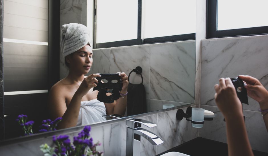 LED skincare face mask device in a modern bathroom setting